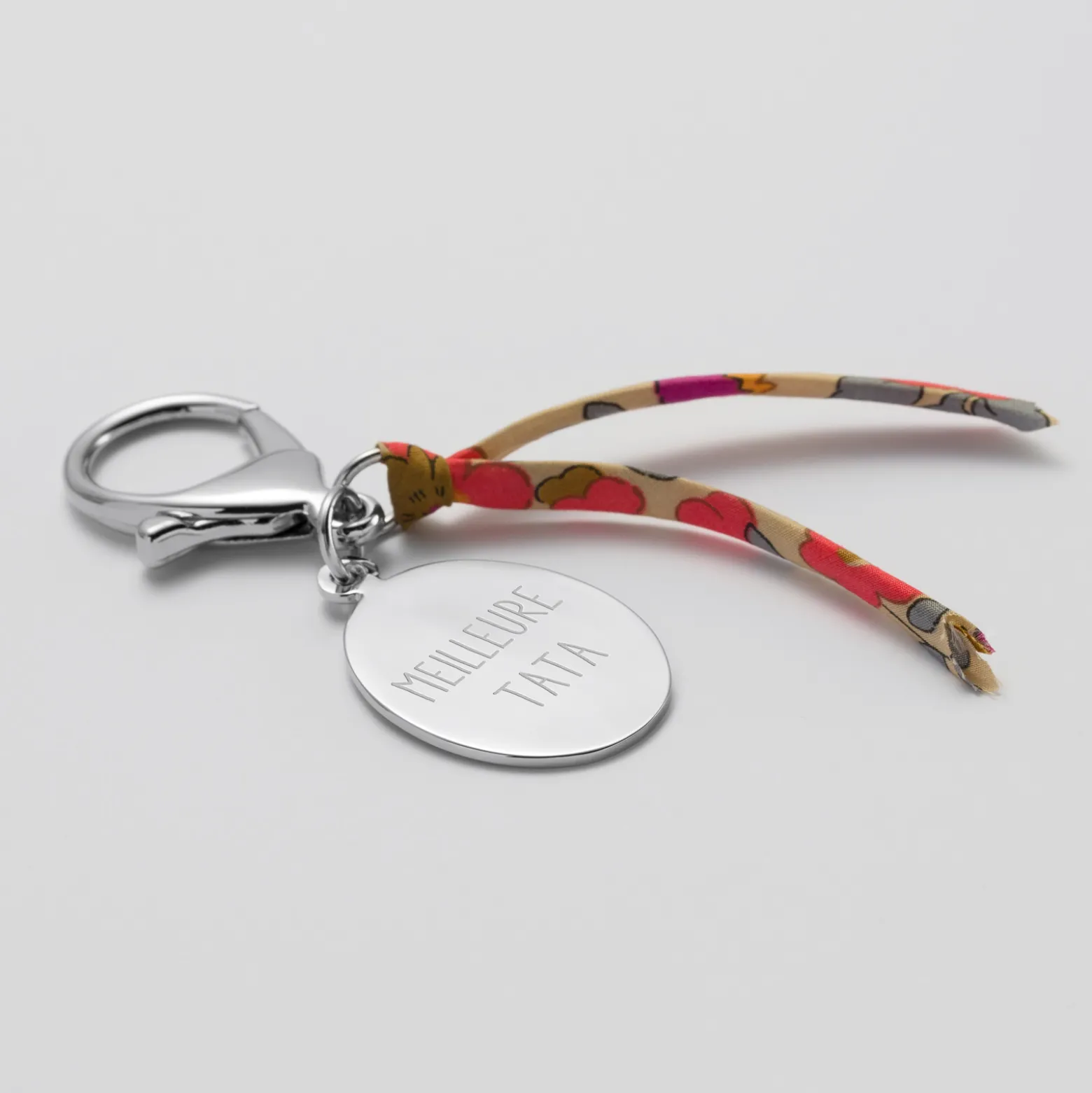 Bijou de sac personnalisé médaille gravée acier ovale 33x25 mm et noeud Liberty