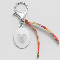 Bijou de sac personnalisé médaille gravée acier ovale 33x25 mm et noeud Liberty