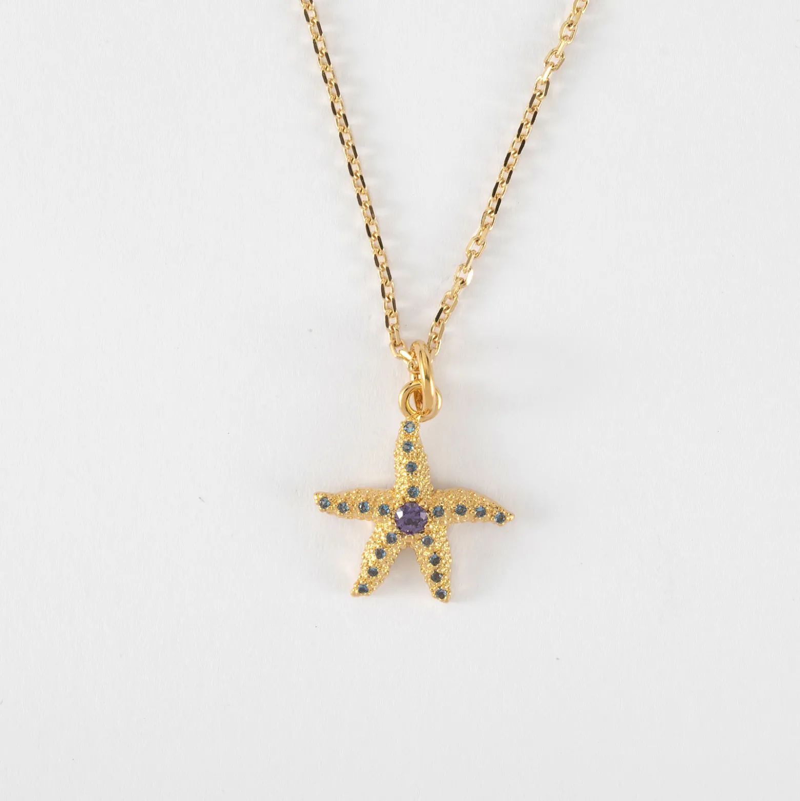 Pendentif enfant étoile de mer scintillante zircons bleus plaqué or 15 mm