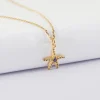 Pendentif étoile de mer scintillante zircons bleus plaqué or 15 mm